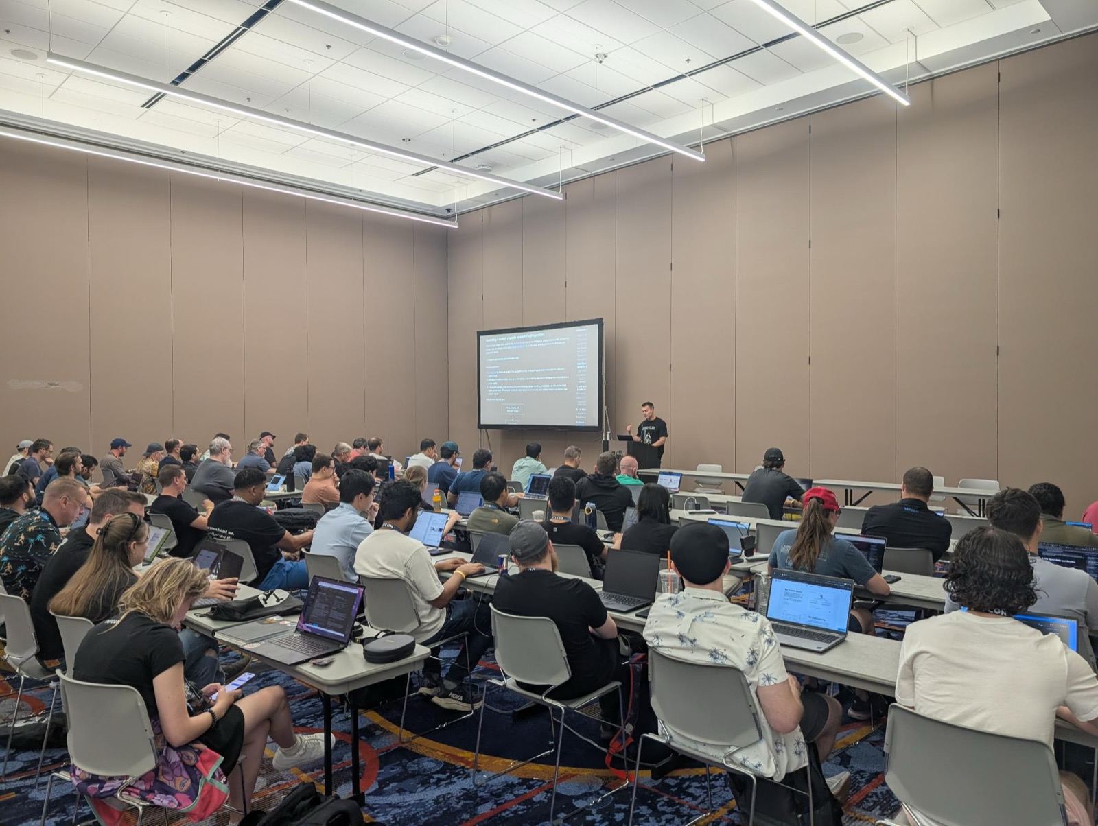 A packed DEF CON 34 Building Agentic RE Skills room full of attendees on laptops